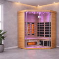 Infrared sauna with purple interior light in a room with a plant and small table.